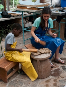 Emmanuel, one of the children of the family I was staying with, and me pounding Paper Mulberry fibers.